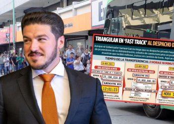 Man in a navy suit and orange tie stands in foreground with a large bus displaying a Spanish-language infographic about a political scam in the background.