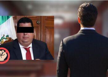 Man in a dark suit with eyes obscured sits in front of a Mexican flag; a red circle with a raised fist overlays the left bottom corner, suggesting protest or censorship.