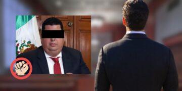 Man in a Dark Suit with Eyes Obscured Sits in Front of a Mexican Flag; a Red Circle with a Raised Fist Overlays the Left Bottom Corner, Suggesting Protest or Censorship. - Especies Políticas