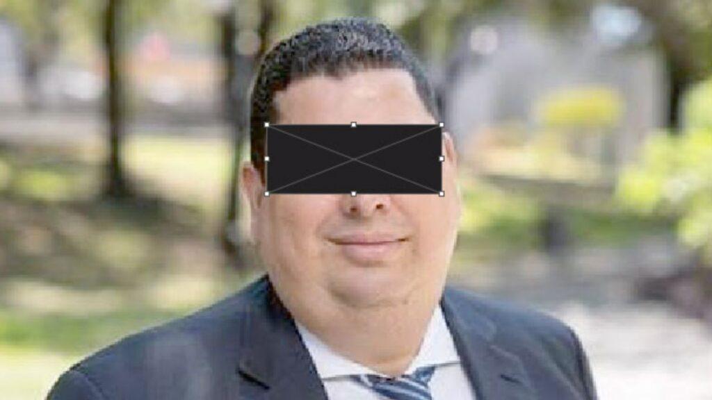 Portrait of a Man in a Suit Outdoors with a Black Censor Bar over His Eyes, Obscuring His Identity, in a Park Setting. - Especies Políticas